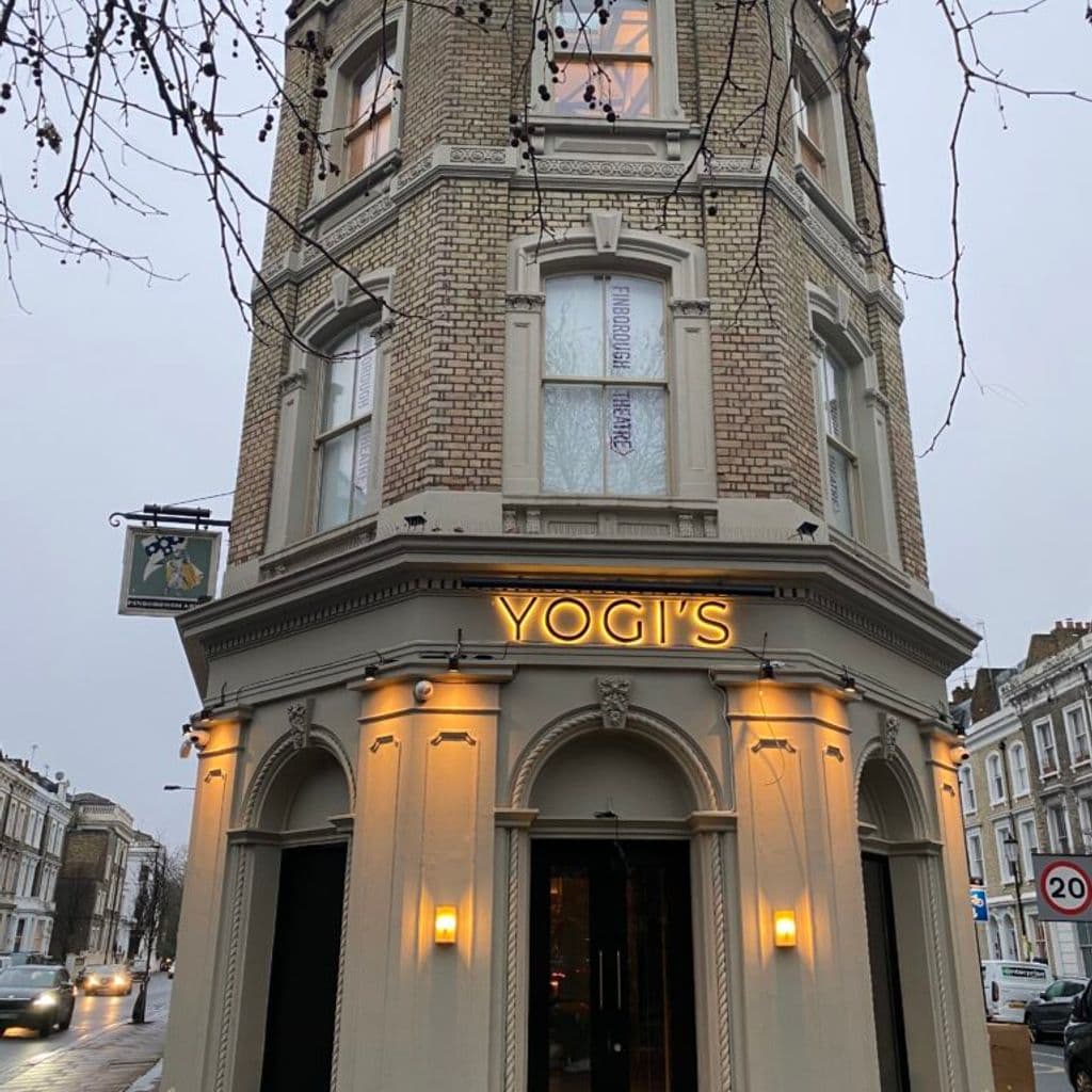 An image of the Finborough Theatre and Yogis at night