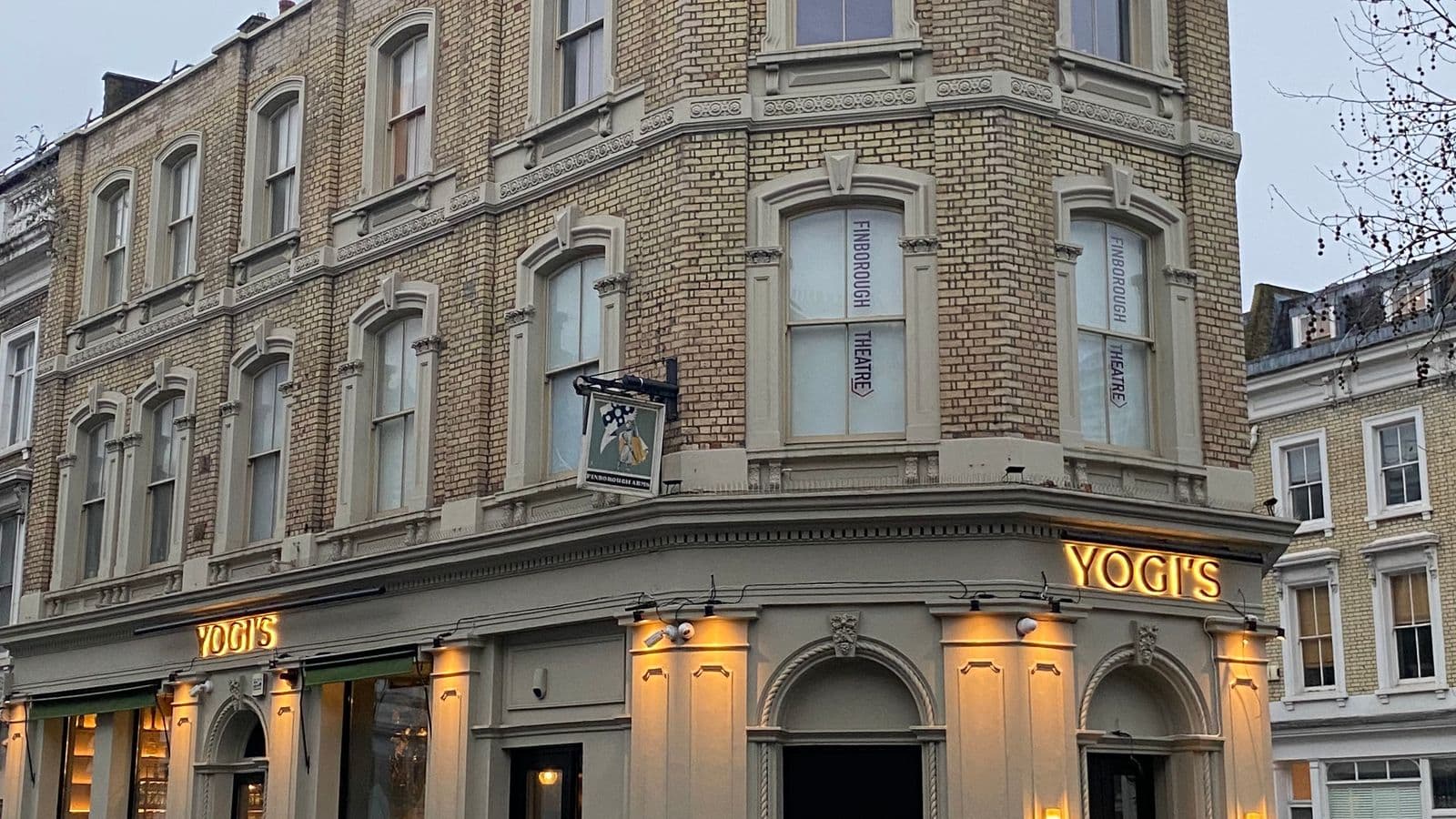 Finborough Theatre and Yogis Restaurant at night sign lit up